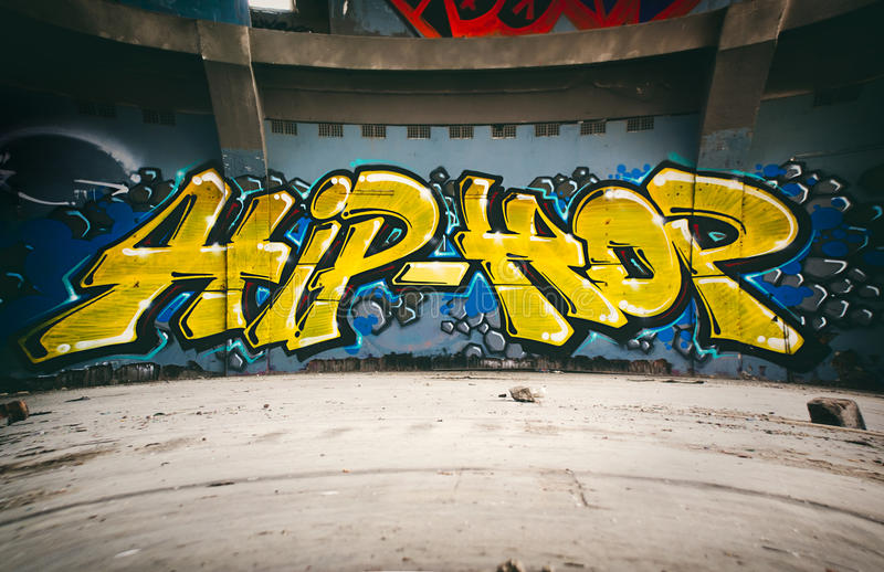 The words "hip-hop" written in graffiti on a wall.