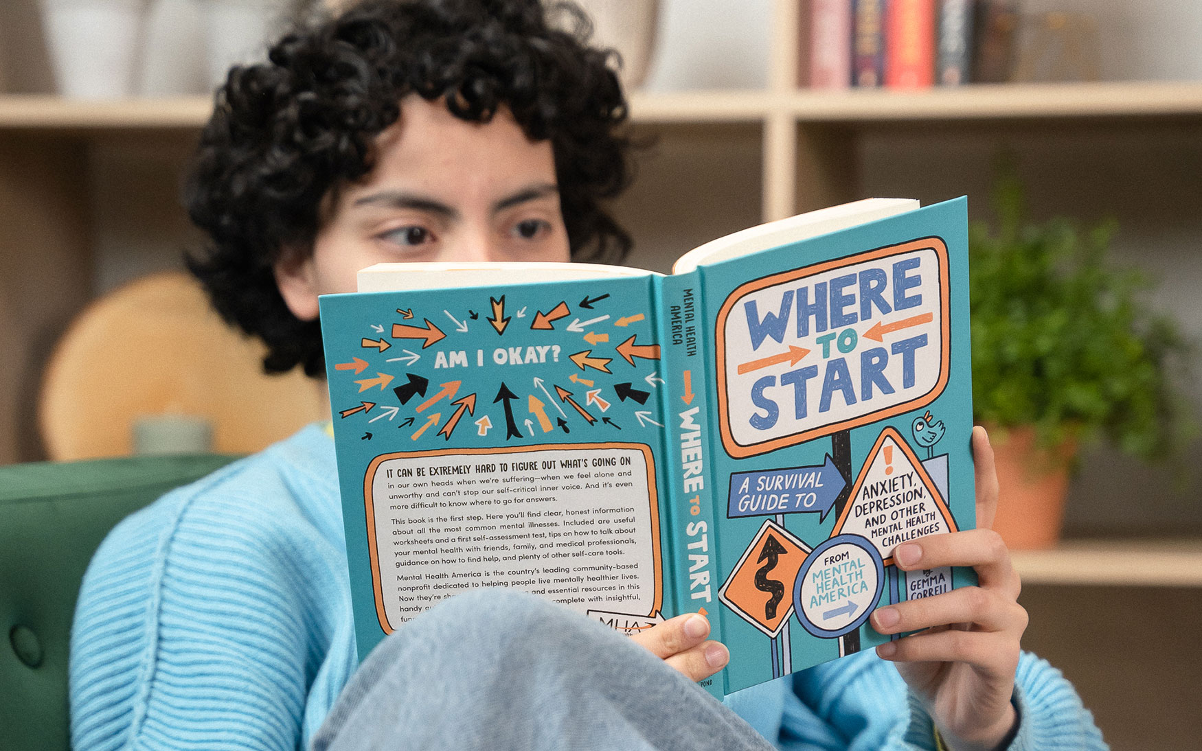 Young person reads Where to Start book by MHA