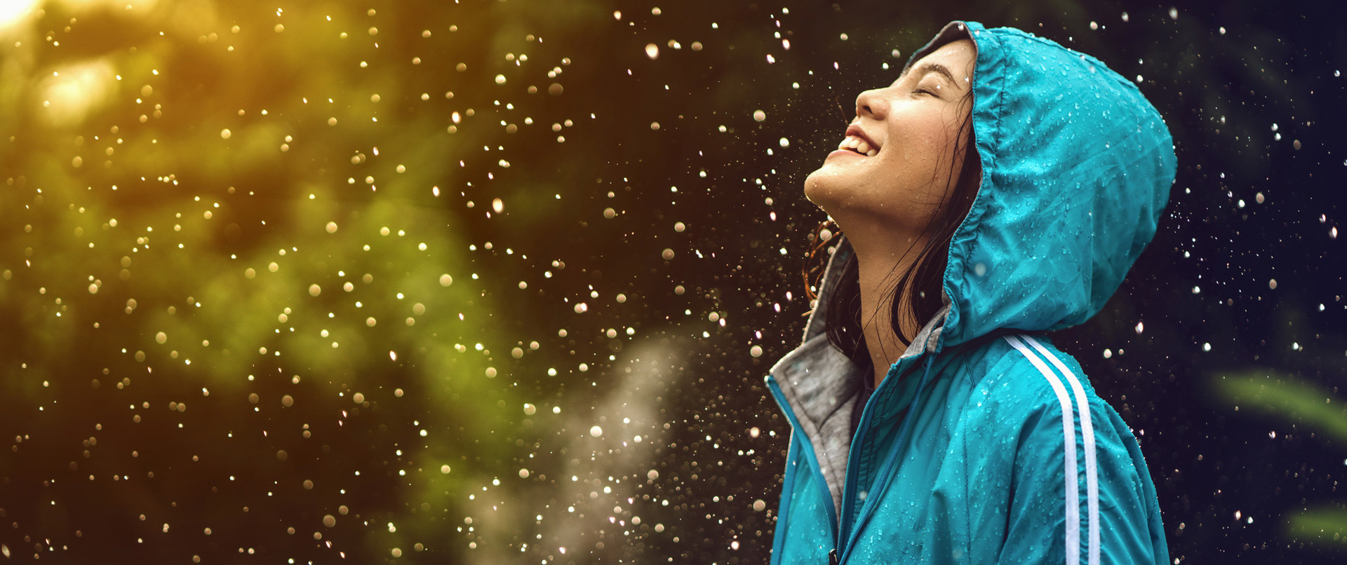 girl looking up in rain happily