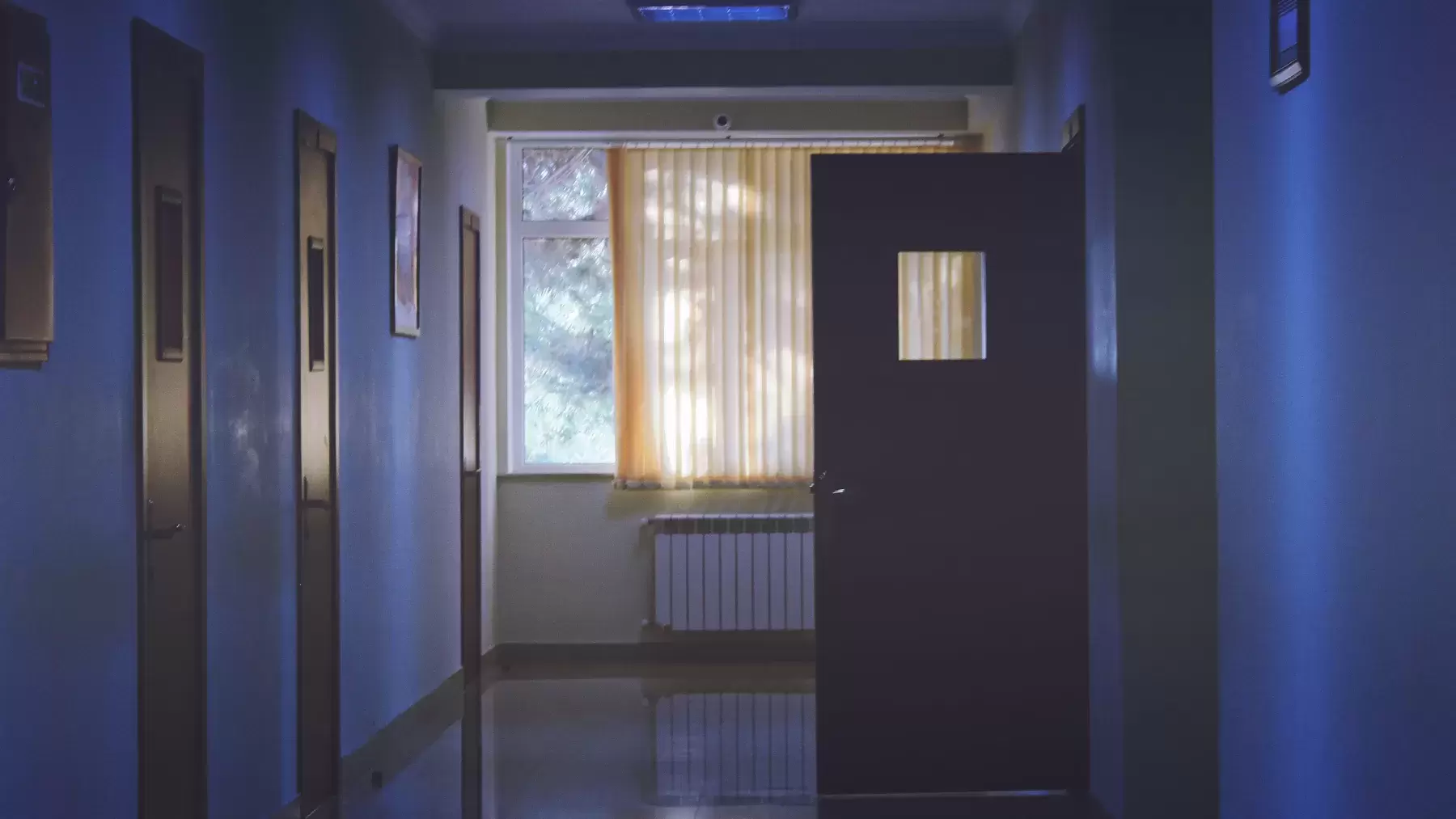 hospital hallway with one open door