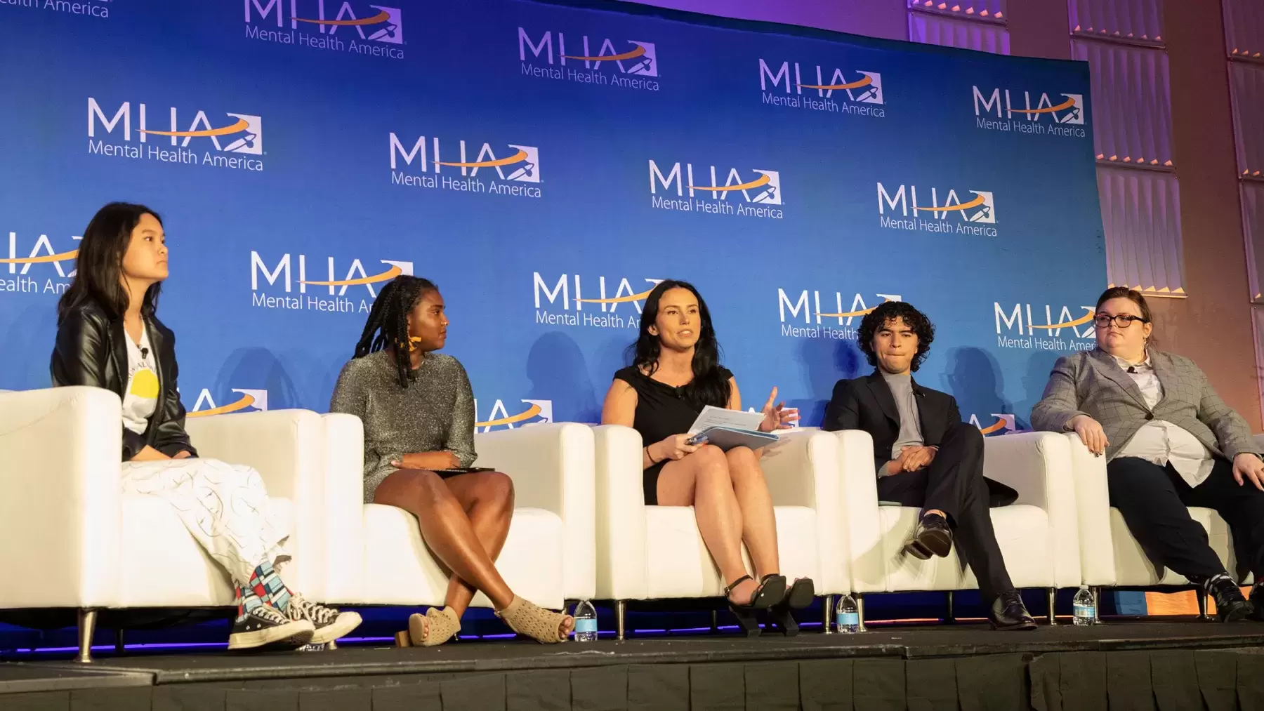 Crystal Widado and members of the Young Leaders Council sit on stage during the youth panel at conference